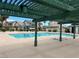 Community pool with a covered pergola, lounge chairs, and view of the surrounding townhomes at 4017 Radbourne Ave, Las Vegas, NV 89121