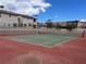 Community tennis court featuring well-maintained green playing surface, and surrounded by lush landscaping at 4017 Radbourne Ave, Las Vegas, NV 89121