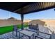 Outdoor patio with comfortable seating, pavers, turf and covered dining area at 4066 Painted Lady Ave, Las Vegas, NV 89141