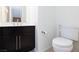Bathroom featuring a black vanity with elegant hardware and fixtures, plus a toilet at 4066 Painted Lady Ave, Las Vegas, NV 89141