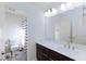 Bright bathroom featuring modern vanity with sink, and a shower with striped curtain at 4066 Painted Lady Ave, Las Vegas, NV 89141