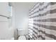 Bright bathroom featuring modern vanity with sink, and a shower with striped curtain at 4066 Painted Lady Ave, Las Vegas, NV 89141