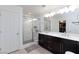 Modern bathroom boasts double sinks, dark wood cabinets, and a tiled shower at 4066 Painted Lady Ave, Las Vegas, NV 89141