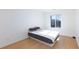 Clean bedroom with light wood flooring, fan, and window at 4066 Painted Lady Ave, Las Vegas, NV 89141