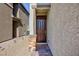 Inviting home entryway with a dark wood door, stone accents, and manicured gravel pathway at 4066 Painted Lady Ave, Las Vegas, NV 89141