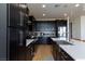 Modern kitchen with sleek black cabinets, stainless steel appliances, and a stylish backsplash at 4066 Painted Lady Ave, Las Vegas, NV 89141