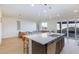 Bright open-concept kitchen featuring stainless steel appliances, modern island, and seamless flow to the living area at 4066 Painted Lady Ave, Las Vegas, NV 89141