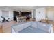 Spacious living area boasts an open layout, hardwood floors, modern décor, and a kitchen in the background at 4066 Painted Lady Ave, Las Vegas, NV 89141