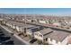An aerial shot of a street with modern homes featuring attached garages, desert landscaping, and solar panels at 4066 Painted Lady Ave, Las Vegas, NV 89141