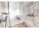 Modern bathroom featuring a soaking tub, marble accents, and shower with sleek hardware at 4381 W Flamingo Rd # 2308, Las Vegas, NV 89103