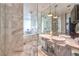 Luxurious bathroom with marble tiling, double vanities, and a glass-enclosed shower at 4381 W Flamingo Rd # 2308, Las Vegas, NV 89103