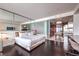 Modern bedroom featuring a sleek design with dark hardwood floors and mirrored accent wall at 4381 W Flamingo Rd # 2308, Las Vegas, NV 89103