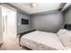 Bedroom with a queen bed, wall-mounted TV, and neutral-colored walls at 4535 Sparwood Dr, Las Vegas, NV 89147