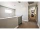 Upstairs hallway with neutral paint, carpet, and white trim at 4535 Sparwood Dr, Las Vegas, NV 89147