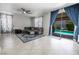 Spacious living room with tile floors, a ceiling fan, and a view of the backyard pool at 4535 Sparwood Dr, Las Vegas, NV 89147