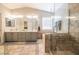 Main bathroom featuring double sinks, a shower, a separate tub, and tile flooring at 4535 Sparwood Dr, Las Vegas, NV 89147