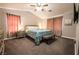 Bright main bedroom with bedside tables, a large bed, and a ceiling fan at 4535 Sparwood Dr, Las Vegas, NV 89147