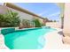 Beautiful backyard pool with a cascading water feature and ample patio space for outdoor entertaining at 4535 Sparwood Dr, Las Vegas, NV 89147