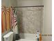 Bathroom featuring a tub and shower combination with neutral tile surround and decor at 5038 S Rainbow Blvd # 206, Las Vegas, NV 89118