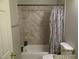 Bathroom featuring a tub and shower combination with neutral tile surround at 5038 S Rainbow Blvd # 206, Las Vegas, NV 89118