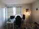 Bedroom with white desk setup, gaming computer, chair, and decorations at 5038 S Rainbow Blvd # 206, Las Vegas, NV 89118