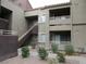 Exterior of an apartment building with staircases, balconies, and desert landscaping at 5038 S Rainbow Blvd # 206, Las Vegas, NV 89118