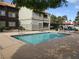 Community pool with sundeck and views of the apartment buildings at 5038 S Rainbow Blvd # 206, Las Vegas, NV 89118