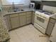 Functional kitchen featuring granite countertops, updated cabinets and stainless steel sink at 5038 S Rainbow Blvd # 206, Las Vegas, NV 89118