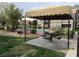 A shaded picnic area overlooks the community pool and green space at 5038 S Rainbow Blvd # 206, Las Vegas, NV 89118
