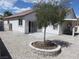 Backyard featuring a stone patio, gravel landscaping, and a covered patio seating area for outdoor relaxation at 5240 Sweet William St, North Las Vegas, NV 89081