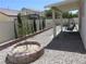 Backyard featuring a stone planter, gravel landscaping, covered patio, and privacy fence, ideal for relaxing at 5240 Sweet William St, North Las Vegas, NV 89081