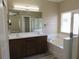 Bright bathroom features a double sink vanity, soaking tub, and separate shower at 5240 Sweet William St, North Las Vegas, NV 89081
