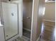 Modern bathroom featuring a glass shower stall, toilet, and access to a bedroom at 5240 Sweet William St, North Las Vegas, NV 89081