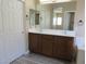 Bright bathroom features a double sink vanity and a door to the hall at 5240 Sweet William St, North Las Vegas, NV 89081