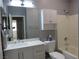 Bright bathroom featuring a white vanity, toilet, and shower-tub combo for a clean, modern aesthetic at 5240 Sweet William St, North Las Vegas, NV 89081