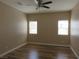 Inviting bedroom featuring hardwood floors, natural light, and a ceiling fan at 5240 Sweet William St, North Las Vegas, NV 89081