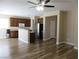 An open-concept design with wood-style flooring, seamlessly connecting living and dining areas at 5240 Sweet William St, North Las Vegas, NV 89081