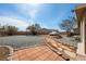 Spacious backyard with desert landscaping, hardscape and a covered vehicle at 5481 Lincolnwood Ct, Pahrump, NV 89061