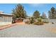 Landscaped backyard with desert plants and a covered patio area, perfect for outdoor living at 5481 Lincolnwood Ct, Pahrump, NV 89061