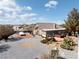 Spacious backyard with desert landscaping, an outdoor patio, and a covered vehicle at 5481 Lincolnwood Ct, Pahrump, NV 89061