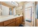 Bathroom features vanity with storage, large mirror, shower and tub at 5481 Lincolnwood Ct, Pahrump, NV 89061