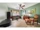 Charming bedroom with a ceiling fan, desk area, and cozy seating; the room is decorated with stylish furniture at 5481 Lincolnwood Ct, Pahrump, NV 89061