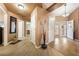 Open concept entry with tile and laminate floors, neutral walls, and arched doorways into other rooms at 5481 Lincolnwood Ct, Pahrump, NV 89061