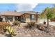 Eye-level view of a home's front yard with desert landscaping and a light brown exterior at 5481 Lincolnwood Ct, Pahrump, NV 89061