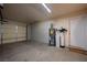 An empty garage with a concrete floor, utility closet, and white walls at 5481 Lincolnwood Ct, Pahrump, NV 89061