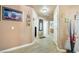 Long hallway featuring light wood floors, neutral colored walls, and multiple entryways at 5481 Lincolnwood Ct, Pahrump, NV 89061