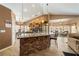 Open concept kitchen with granite island and stainless-steel appliances, flowing into a living room at 5481 Lincolnwood Ct, Pahrump, NV 89061