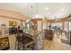 Kitchen featuring a large island with a granite countertop and an open layout into the dining and living area at 5481 Lincolnwood Ct, Pahrump, NV 89061