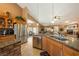 This open eat-in kitchen features granite counters, wood cabinets, stainless appliances and an eat-in dining area at 5481 Lincolnwood Ct, Pahrump, NV 89061