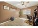 Home office with wood floors, natural light, desk, shredder and ceiling fan at 5481 Lincolnwood Ct, Pahrump, NV 89061